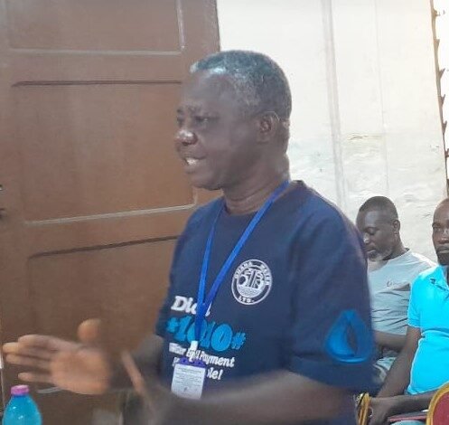 Mr Barnie (inset) addressing residents of Agbogbloshie in Accra
