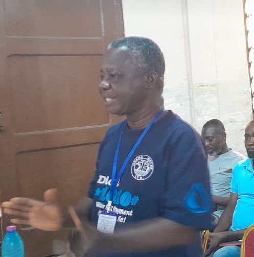 Mr Barnie (inset) addressing residents of Agbogbloshie in Accra