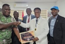 Mr Ayawine (second from right) receiving his award from a representative of the Business Executive after the programme.