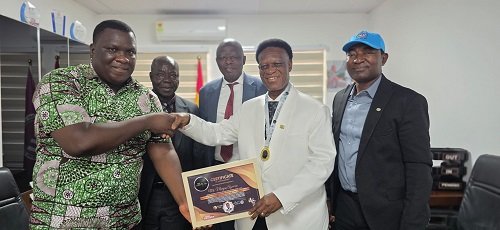 Mr Ayawine (second from right) receiving his award from a representative of the Business Executive after the programme.