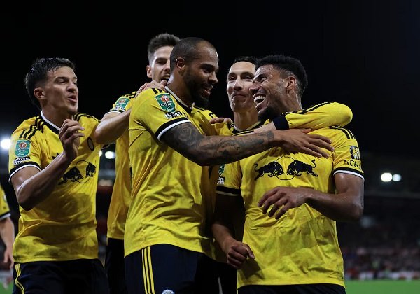 James Justin celebrates their second goal with teammates