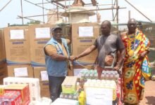Mr. Alfred Allotey-Gaisie (left) presenting a chest freezer to one of the beneficiaries