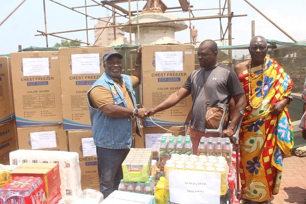 Mr. Alfred Allotey-Gaisie (left) presenting a chest freezer to one of the beneficiaries