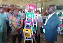Alhaji Faila (right) presenting the furniture to Mr Adjei (second from left)