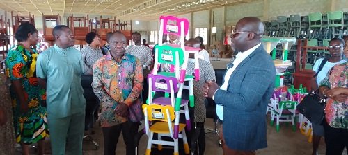 Alhaji Faila (right) presenting the furniture to Mr Adjei (second from left)