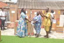 Ms Sowah (left) presenting a cash and item to beneficiary at the ceremony Photo Victor A. Buxton