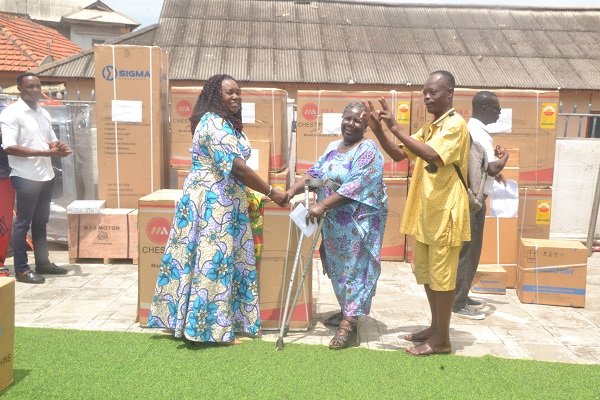 Ms Sowah (left) presenting a cash and item to beneficiary at the ceremony Photo Victor A. Buxton