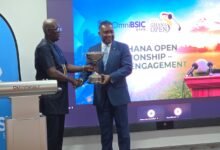 Leonard Kwaku Okyere (L) presenting the tournament men’s trophy to Daniel Asiedu (R) MD of Omnibsic Bank