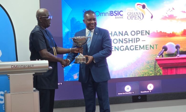 Leonard Kwaku Okyere (L) presenting the tournament men’s trophy to Daniel Asiedu (R) MD of Omnibsic Bank