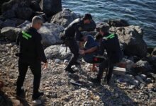 Members of the Spanish Guardia Civil (Civil Guard) detain a migrant