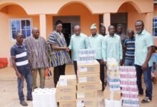 Mr Atagra (fifth from right) presenting the items to an official of the Palace
