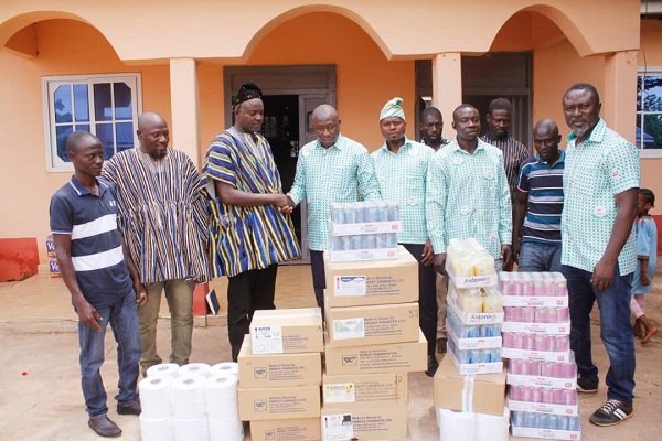 Mr Atagra (fifth from right) presenting the items to an official of the Palace