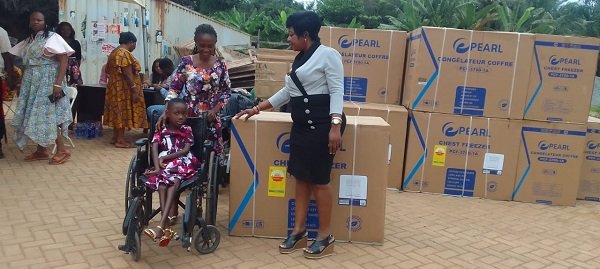 Ms Korankye (right) presenting a deep freezer to a beneficiary
