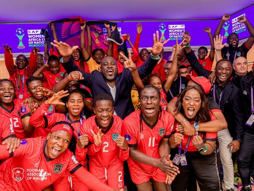Players and officals of Malawi celebrating their historic qualification