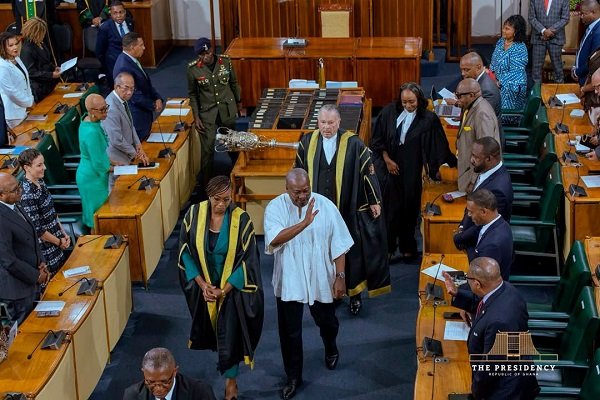 President Mahama (middle in smock) leaving the chamber after addressing a joint sitting of the Jamaican Parliament