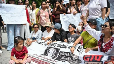 Protesters hold a banner showing the face of the child who was killed