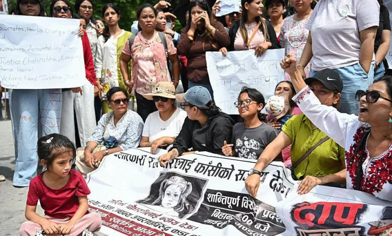 Protesters hold a banner showing the face of the child who was killed