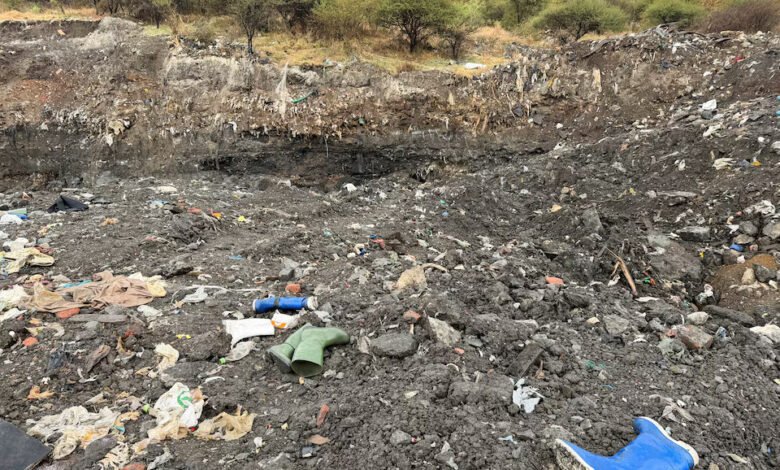 Rubber boots believed to belong to illegal miners lay near a shaft entrance at a disused mine