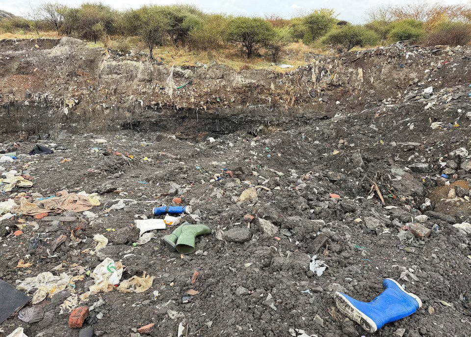 Rubber boots believed to belong to illegal miners lay near a shaft entrance at a disused mine