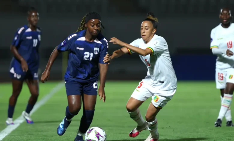 Saratou Traore of Mali comes under a challenge from Larissa Patricia and Silva Melo of Cape Verde during the match