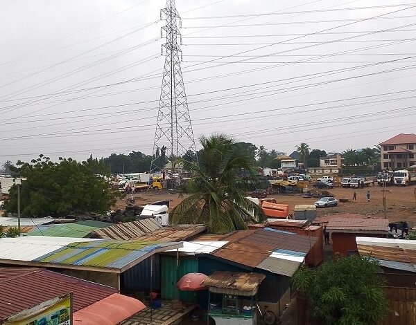 Some wooden shops and kiosk operating under the transmission lines Photo Victor A. Buxton