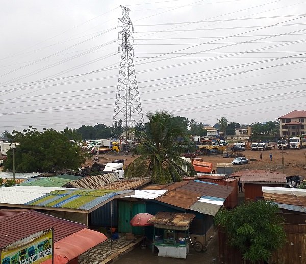 Some wooden shops and kiosk operating under the transmission lines Photo Victor A. Buxton