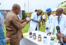 President Mahama (left) inspecting samples of refined petroleum products at the Tema Oil Refinery