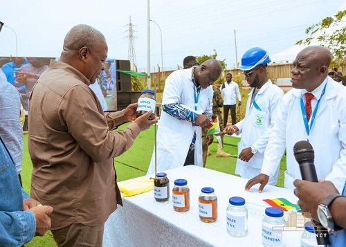 President Mahama (left) inspecting samples of refined petroleum products at the Tema Oil Refinery