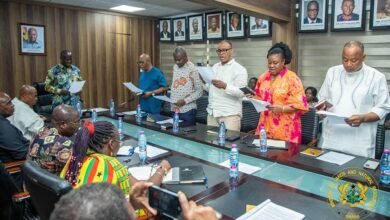 Mr Armah-Kofi Buah (head of table) swearing in members at the inauguration