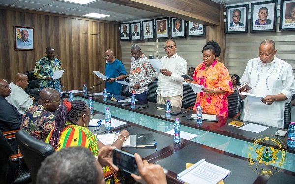 Mr Armah-Kofi Buah (head of table) swearing in members at the inauguration