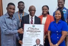 Mr Seth Terkper (middle) receiveing a citation of appreciation and honour from UFO officials