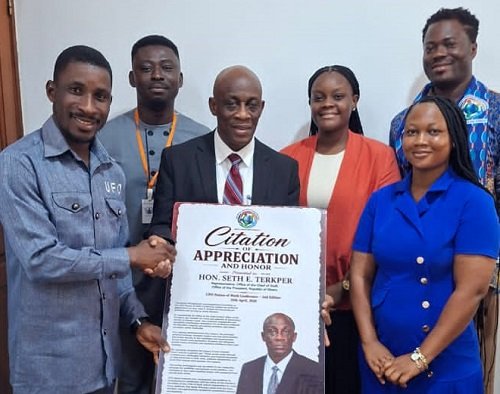 Mr Seth Terkper (middle) receiveing a citation of appreciation and honour from UFO officials