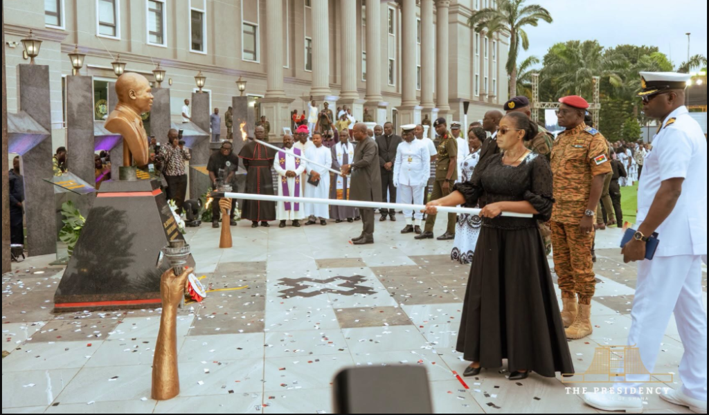 President Mahama and the wife of the late Dr. Edward Omane Boamah lighting a perpetual flame at the unveiling of a cenotaph in honour of the late Defence Minister