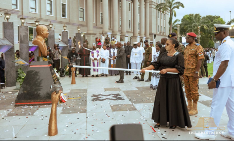 President Mahama and the wife of the late Dr. Edward Omane Boamah lighting a perpetual flame at the unveiling of a cenotaph in honour of the late Defence Minister