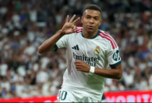 Kylian Mbappe celebrates scoring a hat-trick and his team's fourth goal