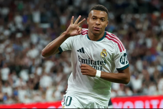 Kylian Mbappe celebrates scoring a hat-trick and his team's fourth goal