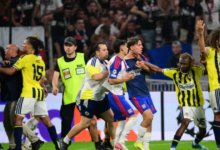 Fenerbahce's Nene Dorgeles tries to seperate teammates Matteo Guendouzi (R) and Lyon's players