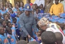 Mr Gorg presenting uniforms to the pupils