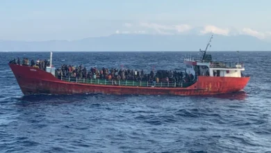 A cargo ship carries migrants during a rescue operation as it sails off the island of Crete, Greece
