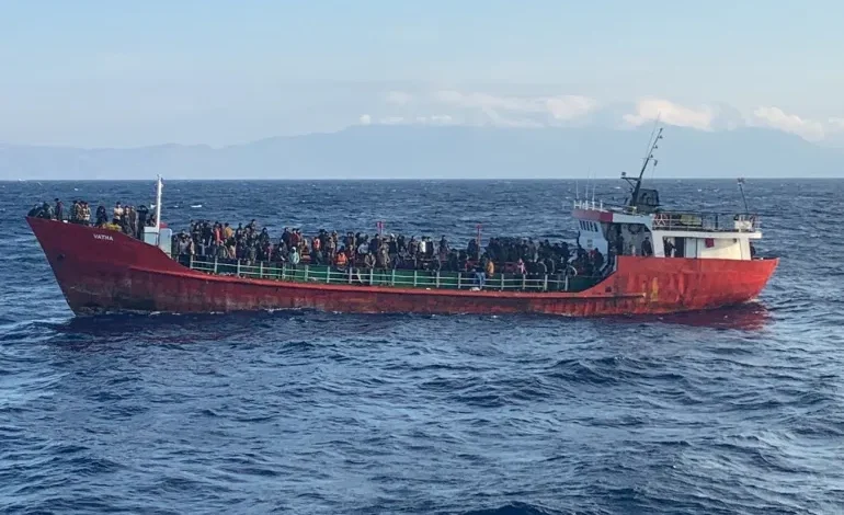 A cargo ship carries migrants during a rescue operation as it sails off the island of Crete, Greece
