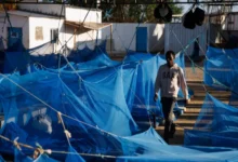 A man walks through a male dormitory at an International Organization for Migration transit centre for migrants in Obock, Djibouti