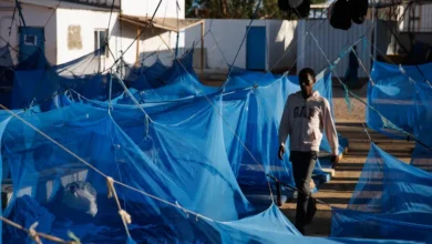 A man walks through a male dormitory at an International Organization for Migration transit centre for migrants in Obock, Djibouti