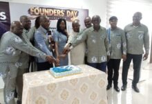 Mr Emmanuel K.Cobbold (third from left) with other dignitaries cutting the anniversary cake