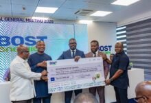Mr Awoonor (second from right) presenting the dummy cheque to Dr Jinapor (second from left). With them are Prof Micheal Kpessa-Whyte (left) and officials from BOSTenergies