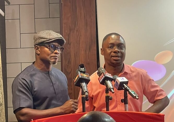 Rev. Agyapong (left) speaking at the programme. With him is Mr Agbo