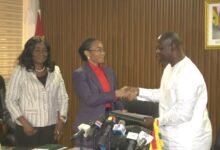 Dr Agyeman-Rawlings (middle) receiving handing over documents from Armah-Kofi Buah at the ceremony Photo Victor A. Buxton
