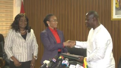 Dr Agyeman-Rawlings (middle) receiving handing over documents from Armah-Kofi Buah at the ceremony Photo Victor A. Buxton