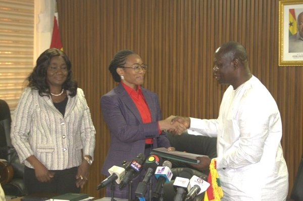 Dr Agyeman-Rawlings (middle) receiving handing over documents from Armah-Kofi Buah at the ceremony Photo Victor A. Buxton