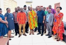 Nana Osei Yaw Frimpong II (middle) with ECG staff during the visit