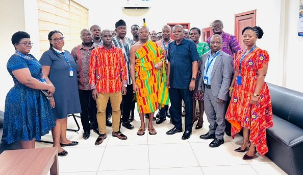 Nana Osei Yaw Frimpong II (middle) with ECG staff during the visit